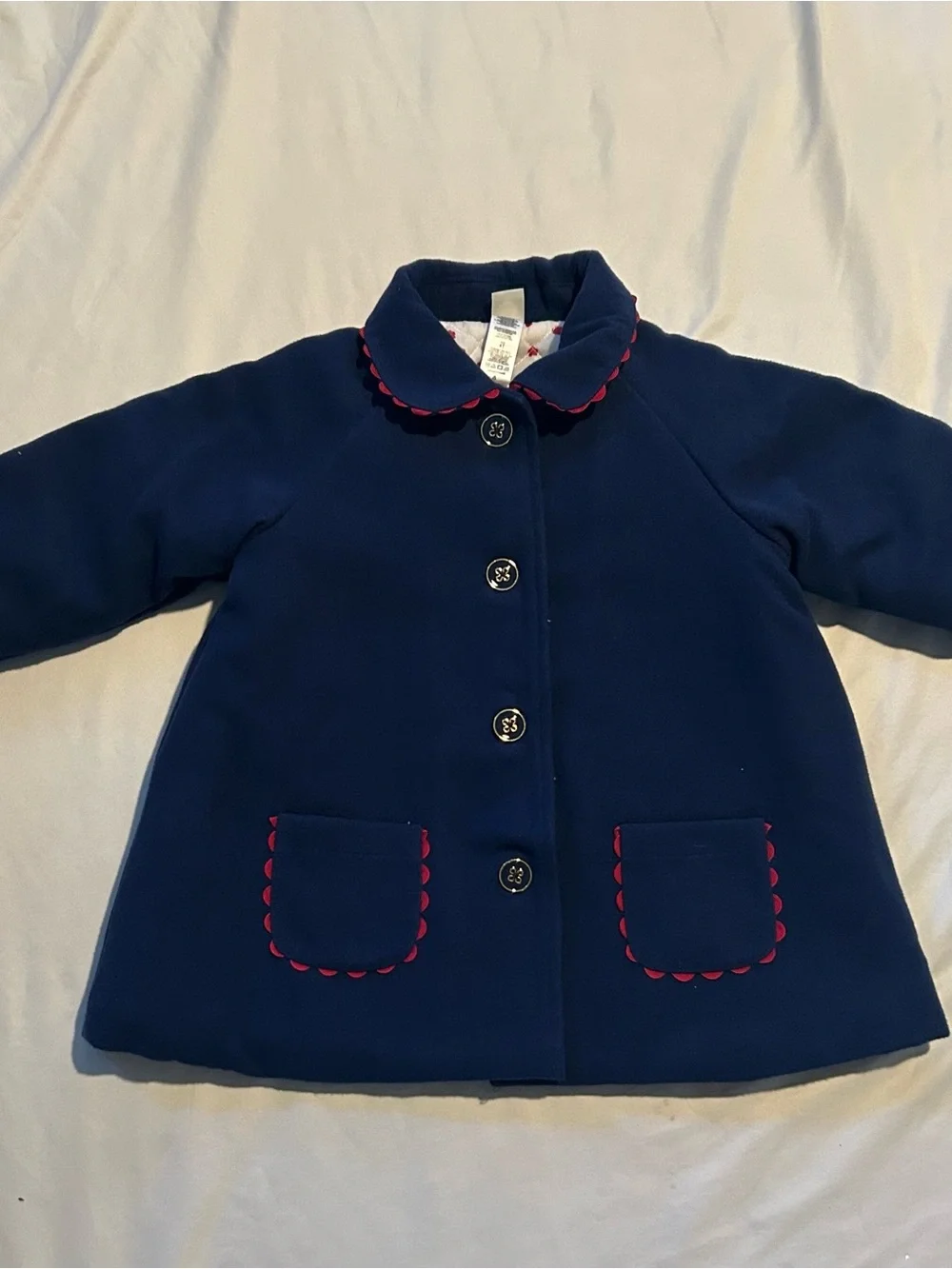 Little Me Navy Pea Coat with Red Scallop Trim and Bow.